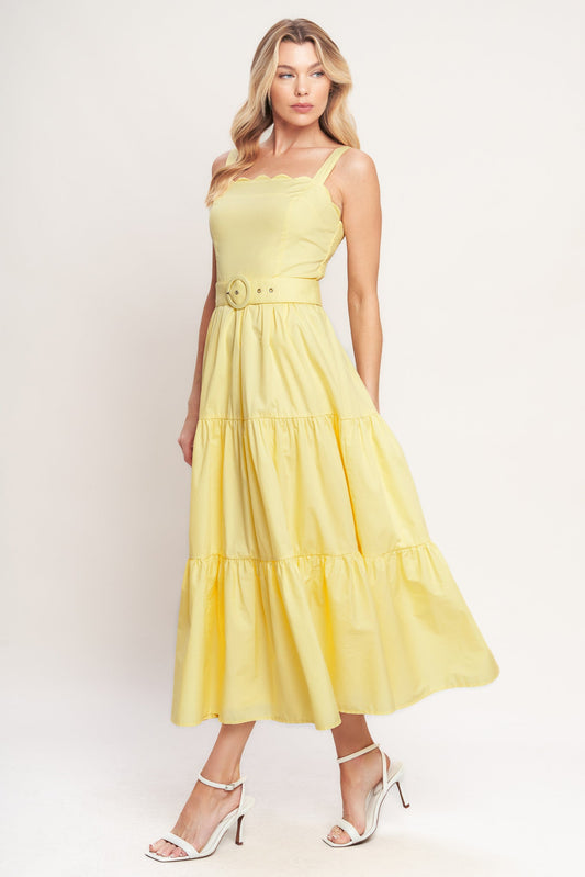 Woman wearing a yellow dress against a white background
