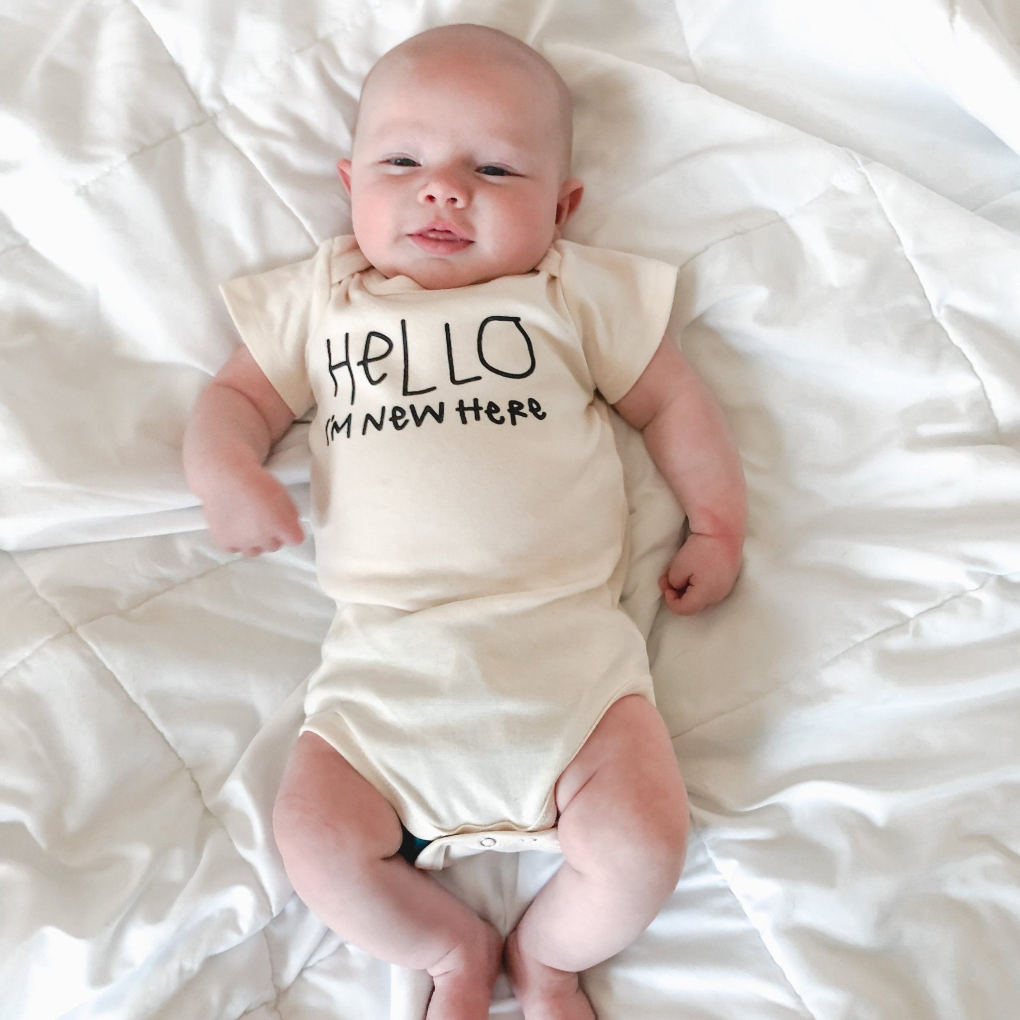 HELLO I'M NEW HERE ORGANIC BABY BODYSUIT